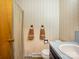 Cozy bathroom with floral wallpaper and towel rings for added convenience at 1309 Briarcliff Rd, Shelby, NC 28152