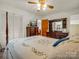 Bedroom featuring a four-poster bed, dresser, and white closet doors, providing comfort and storage at 1309 Briarcliff Rd, Shelby, NC 28152