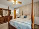 Cozy bedroom features a four-poster bed and dresser with a mirror, radiating warmth and comfort at 1309 Briarcliff Rd, Shelby, NC 28152
