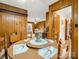 Comfortable dining room featuring wood paneling and a doorway leading to the living area at 1309 Briarcliff Rd, Shelby, NC 28152