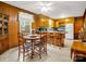 Quaint kitchen with wooden cabinetry, breakfast bar, and adjacent dining area at 1309 Briarcliff Rd, Shelby, NC 28152