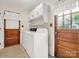 Bright laundry room featuring a washer, dryer, and ample storage cabinets for convenience at 1309 Briarcliff Rd, Shelby, NC 28152