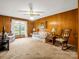 Cozy living room with wood paneled walls, a plush sofa, and a comfortable rocking chair at 1309 Briarcliff Rd, Shelby, NC 28152