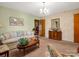 Traditional living room with patterned wallpaper, sofa, and access to other rooms at 1309 Briarcliff Rd, Shelby, NC 28152
