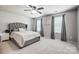 Bedroom with ceiling fan and large windows at 13715 Sunrise View Dr, Charlotte, NC 28278