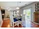 Breakfast area with natural light and hardwood floors that leads into the living room and out to the patio at 13715 Sunrise View Dr, Charlotte, NC 28278