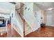 Hallway with hardwood floors and carpeted stairs that leads to the living area and bedrooms at 13715 Sunrise View Dr, Charlotte, NC 28278