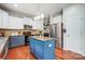 Kitchen with island, stainless steel appliances, granite countertops, tile backsplash and hardwood floors at 13715 Sunrise View Dr, Charlotte, NC 28278