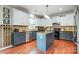 Open kitchen with stainless steel appliances, white cabinets, kitchen island, granite countertops and hardwood floors at 13715 Sunrise View Dr, Charlotte, NC 28278