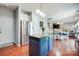 Kitchen with stainless steel appliances, island, hardwood floors that leads into the breakfast and living area at 13715 Sunrise View Dr, Charlotte, NC 28278