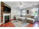 Comfortable living room with a decorative fireplace, flat screen TV, plush sectional, and hardwood floors at 13715 Sunrise View Dr, Charlotte, NC 28278