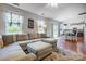 Open-concept living room flowing into the kitchen, featuring a large sectional and hardwood floors at 13715 Sunrise View Dr, Charlotte, NC 28278