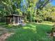 Backyard featuring a screened gazebo and mature trees for added privacy and shade at 148 Palaside Ne Dr, Concord, NC 28025