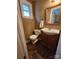Bathroom with a wood vanity, an oval mirror, a toilet and a window for natural light at 148 Palaside Ne Dr, Concord, NC 28025