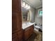 Bathroom featuring a vanity with a white countertop, wood cabinets, and a large framed mirror at 148 Palaside Ne Dr, Concord, NC 28025