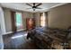 Cozy bedroom with wood floors, ceiling fan, natural light, neutral walls, and ample closet space at 148 Palaside Ne Dr, Concord, NC 28025