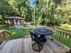 Deck featuring wrought iron table and chairs, with a screened gazebo and mature trees at 148 Palaside Ne Dr, Concord, NC 28025