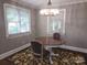 Charming dining room with chandelier lighting, wood table, and neutral walls with large windows at 148 Palaside Ne Dr, Concord, NC 28025