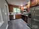 Spacious kitchen with stainless steel appliances, modern countertops, and gray tile flooring at 148 Palaside Ne Dr, Concord, NC 28025