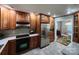 Well-lit kitchen with wood cabinets, stainless steel appliances, tile floors, and contrasting countertops at 148 Palaside Ne Dr, Concord, NC 28025