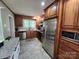 Bright kitchen with stainless steel appliances, wood cabinets, stone countertops, undermount sink, and tile floors at 148 Palaside Ne Dr, Concord, NC 28025