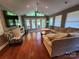 Spacious living room with hardwood floors, ceiling fan, large windows, and access to the outdoor deck at 148 Palaside Ne Dr, Concord, NC 28025