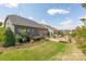 A lovely back yard featuring a spacious deck, lush green grass, and well-maintained landscaping provides great outdoor appeal at 16004 Tulloch Rd, Charlotte, NC 28278