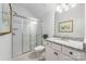 Compact bathroom with granite counters, a glass shower, and bright white walls and cabinetry at 16004 Tulloch Rd, Charlotte, NC 28278
