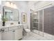 Modern bathroom with a gray tiled shower, sleek vanity, and stylish fixtures at 16004 Tulloch Rd, Charlotte, NC 28278