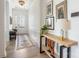 Bright entryway with natural light, hardwood floors, console table, and decorative art at 16004 Tulloch Rd, Charlotte, NC 28278