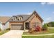 Charming single-Gathering home with a brick facade, well-manicured lawn, and beautiful landscaping at 16004 Tulloch Rd, Charlotte, NC 28278