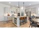 Modern kitchen with a large island, stainless steel appliances, and stylish pendant lights at 16004 Tulloch Rd, Charlotte, NC 28278