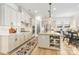 Modern kitchen featuring white cabinets, a spacious island, and an open layout perfect for entertaining at 16004 Tulloch Rd, Charlotte, NC 28278