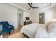 Bright main bedroom with tray ceilings, ceiling fan, wooden floors and ensuite bathroom at 16004 Tulloch Rd, Charlotte, NC 28278