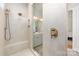 Walk-in shower featuring hexagon tiling, a built-in bench, and premium bronze fixtures at 16004 Tulloch Rd, Charlotte, NC 28278