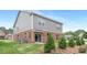 Backyard view of the home with a sliding glass door and small trees at 1701 30Th Avenue Ne Ct, Hickory, NC 28601