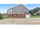 Home exterior featuring gray siding, brick, garage, and spacious backyard at 1701 30Th Avenue Ne Ct, Hickory, NC 28601