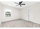 Light filled bedroom featuring plush carpet, a ceiling fan, and a street view at 1701 30Th Avenue Ne Ct, Hickory, NC 28601