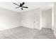 An airy bedroom featuring a ceiling fan, two doors, and plush carpeting at 1701 30Th Avenue Ne Ct, Hickory, NC 28601