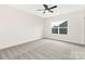 Light filled bedroom featuring plush carpet, a ceiling fan, and an exterior view at 1701 30Th Avenue Ne Ct, Hickory, NC 28601