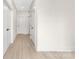 Hallway showing multiple doors, light walls, and wood floors at 1701 30Th Avenue Ne Ct, Hickory, NC 28601