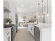Bright, open kitchen with stainless steel appliances, white cabinets and large island at 1701 30Th Avenue Ne Ct, Hickory, NC 28601