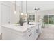 Bright and open kitchen with white cabinetry, modern fixtures, and a spacious island countertop at 1701 30Th Avenue Ne Ct, Hickory, NC 28601
