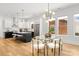 Open-concept dining room with a modern glass table and stylish chairs, complemented by natural light and contemporary lighting at 2008 St John St, Charlotte, NC 28216