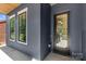Close-up of a modern home's entrance featuring a glass door, stylish siding, and modern windows at 2008 St John St, Charlotte, NC 28216