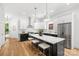 Elegant kitchen with stainless steel appliances, white cabinetry, a large island, and modern lighting at 2008 St John St, Charlotte, NC 28216