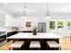 Bright kitchen featuring a large center island, pendant lighting, stainless steel appliances, and ample countertop space at 2008 St John St, Charlotte, NC 28216
