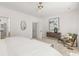 Bright main bedroom featuring neutral decor, a ceiling fan, and an ensuite bathroom and a walk-in closet at 2008 St John St, Charlotte, NC 28216
