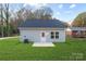Well-maintained backyard with lush lawn, patio, and view of the back exterior of the house at 203 Park Ave, Mount Holly, NC 28120