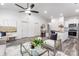 Spacious living area with white walls, modern furniture, and an open layout connecting to the kitchen at 203 Park Ave, Mount Holly, NC 28120